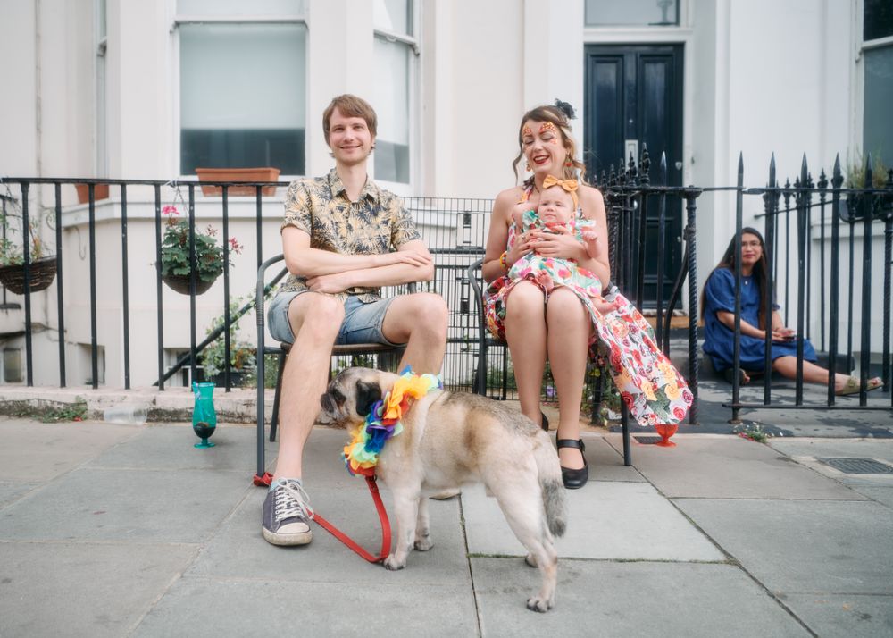 London, England, United Kingdom - August 28, 2022: Young family sitting outside home