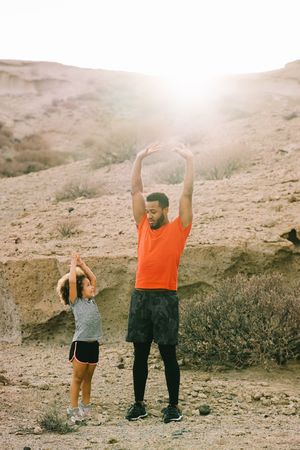 Black father preparing for sport training with child