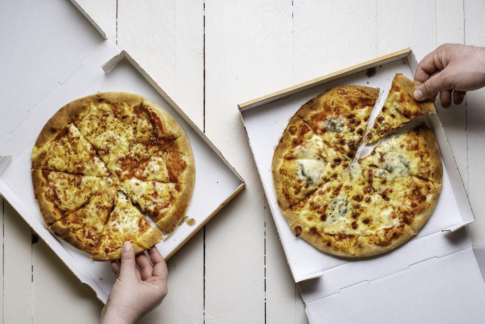 Taking pizza slices from to-go boxes