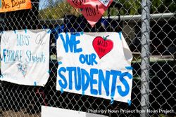 Handmade signs from teachers to students taped to a school fence during distance learning 426m14