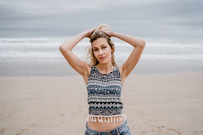 Happy female posing on sandy beach
