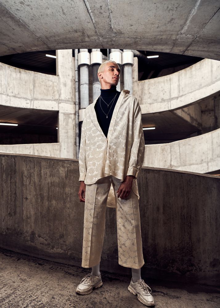 Young man standing tall in a cement structure
