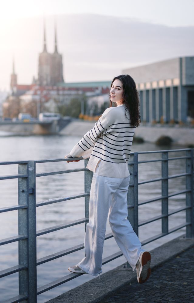 Young woman in trendy summer  clothes at sunset