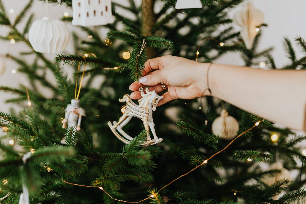 Person holding silver Christmas ornament