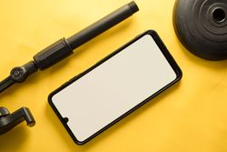 Mock up phone and dismantled stand on yellow table
