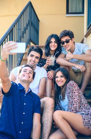 Smiling people taking a selfie with smartphone