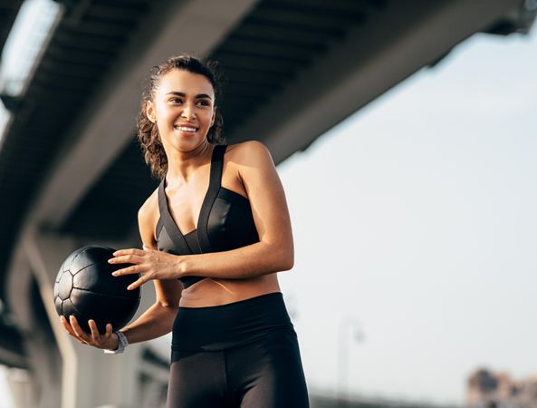 Woman holding medicine ball exercising