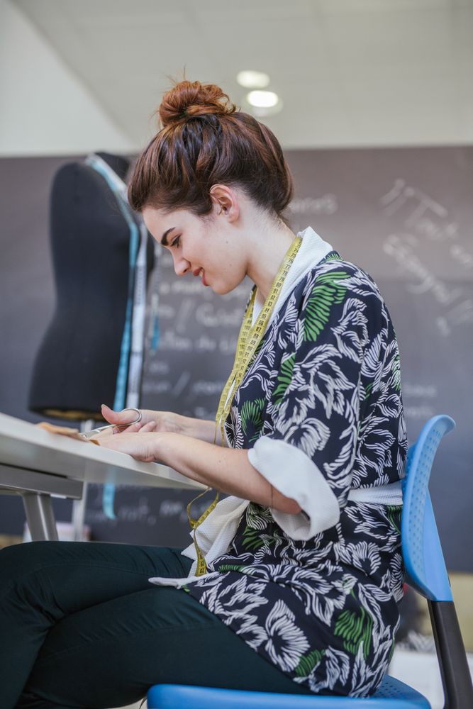 Woman in a sewing school