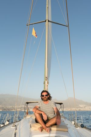 Smiling man on yacht on water