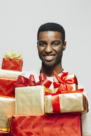 Portrait of Black man behind to many wrapped presents