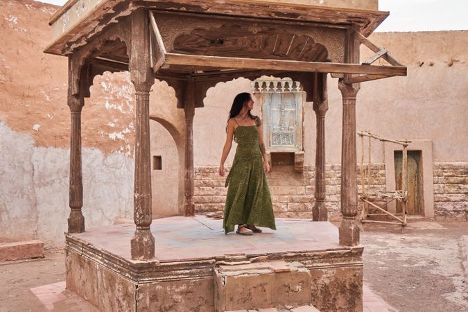 Woman dancing on street stage between ancient buildings