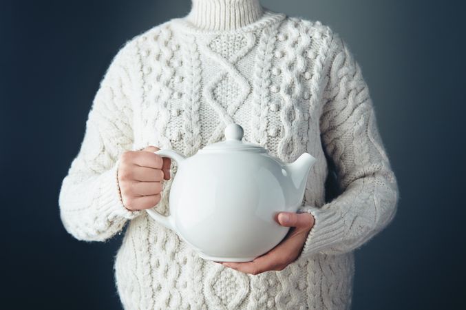 Woman holding big tea pot