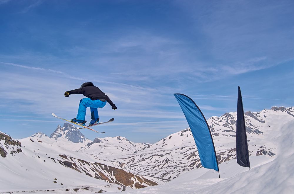 Unrecognizable snowboarder jumping on slope