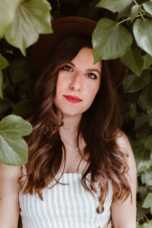 Fashionable woman in front of hedge