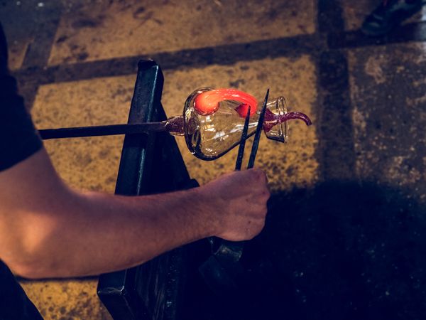Crop craftsman making glass decanter