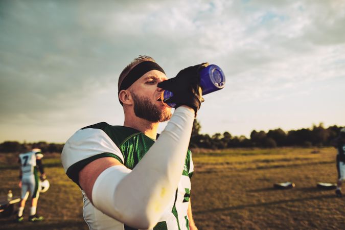 Man drinking water after a football game