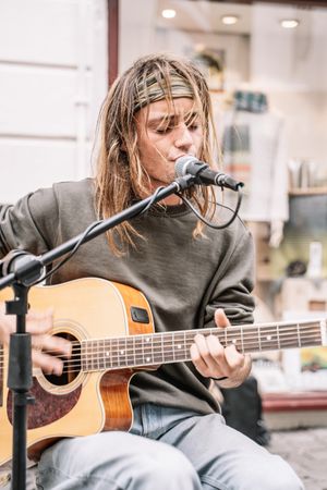 Male musician performing in the street
