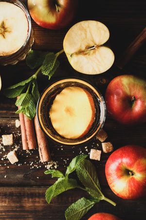 Composition with cider, sugar, cinnamon and apples on wooden table