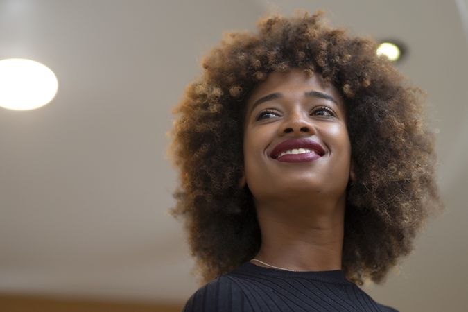 Smiling Black woman looking away