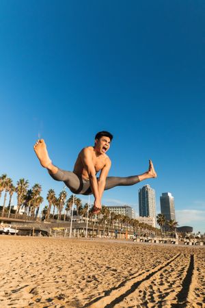 Strong man jumping high during outdoor workout