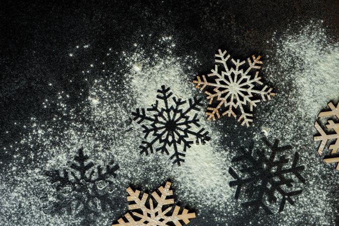 Flour scattered on decorative snow flakes