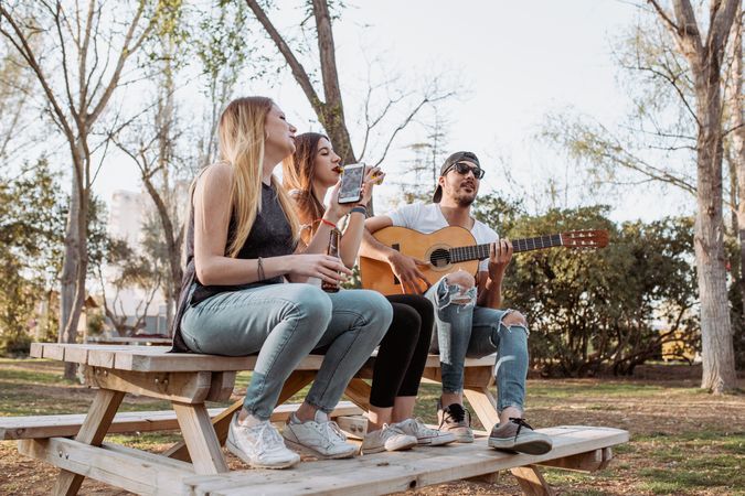 Cheerful musicians having fun in park