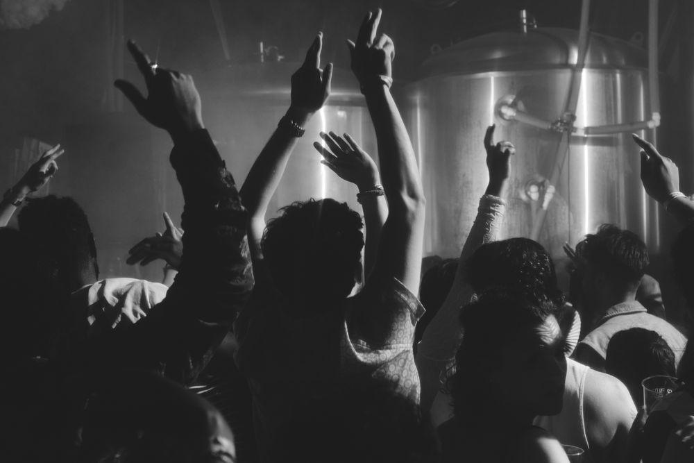 London, England, United Kingdom - Nov 9, 2022: People with their hands up on the dance floor
