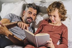 Father and son reading bed time story