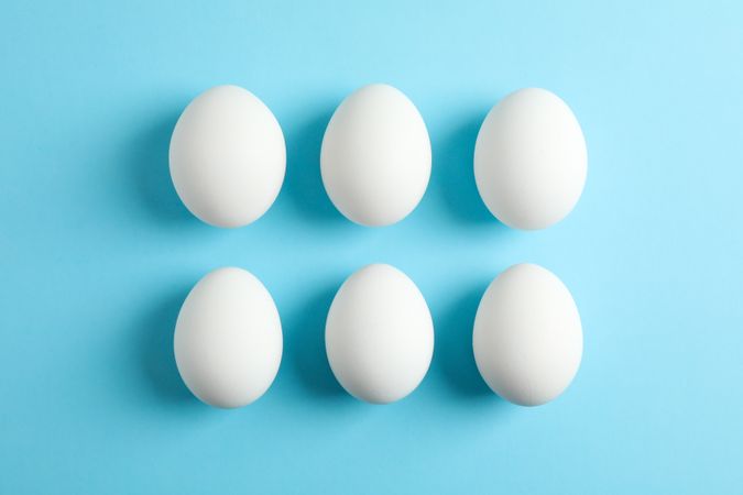 Flat lay composition with chicken eggs on color background, space for text