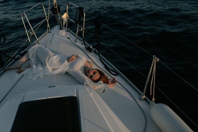 Woman in luxury dress resting on yacht