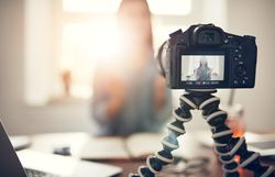 Woman filming herself at her home office