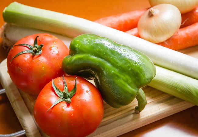 Fresh vegetables on cutting board in the kitchen