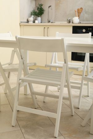 Kitchen interior with wooden table and folding chairs
