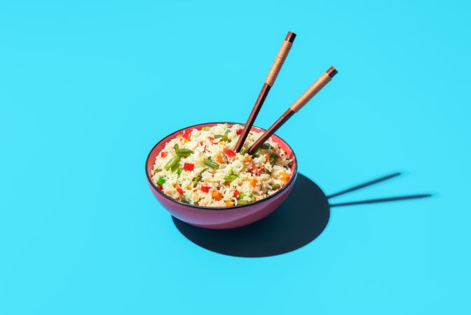 Fried rice bowl isolated on a blue background
