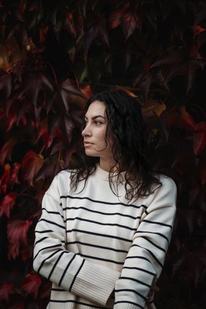 Fashion woman on a background of red and yellow autumn leaves