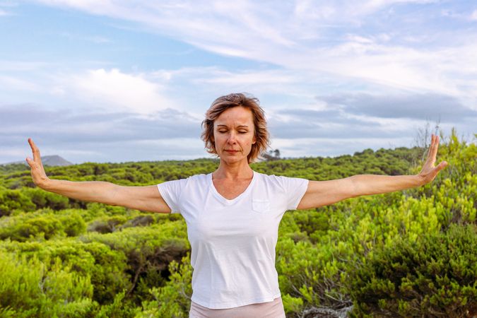 Adult woman practicing martial arts in nature