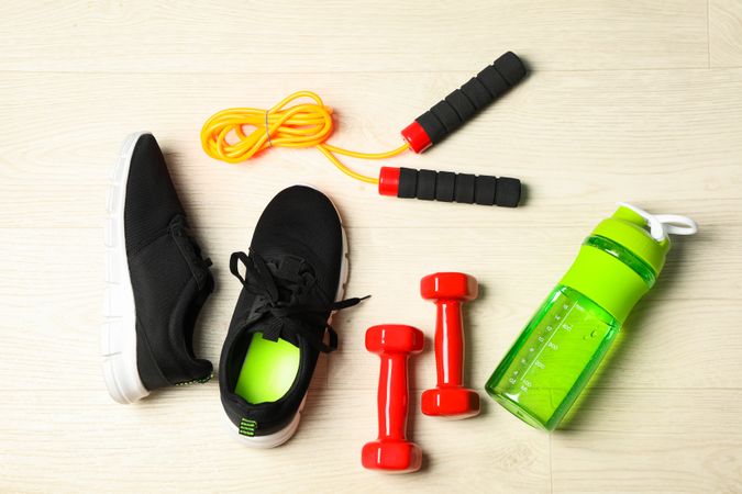 Healthy lifestyle accessories on blank background, top view