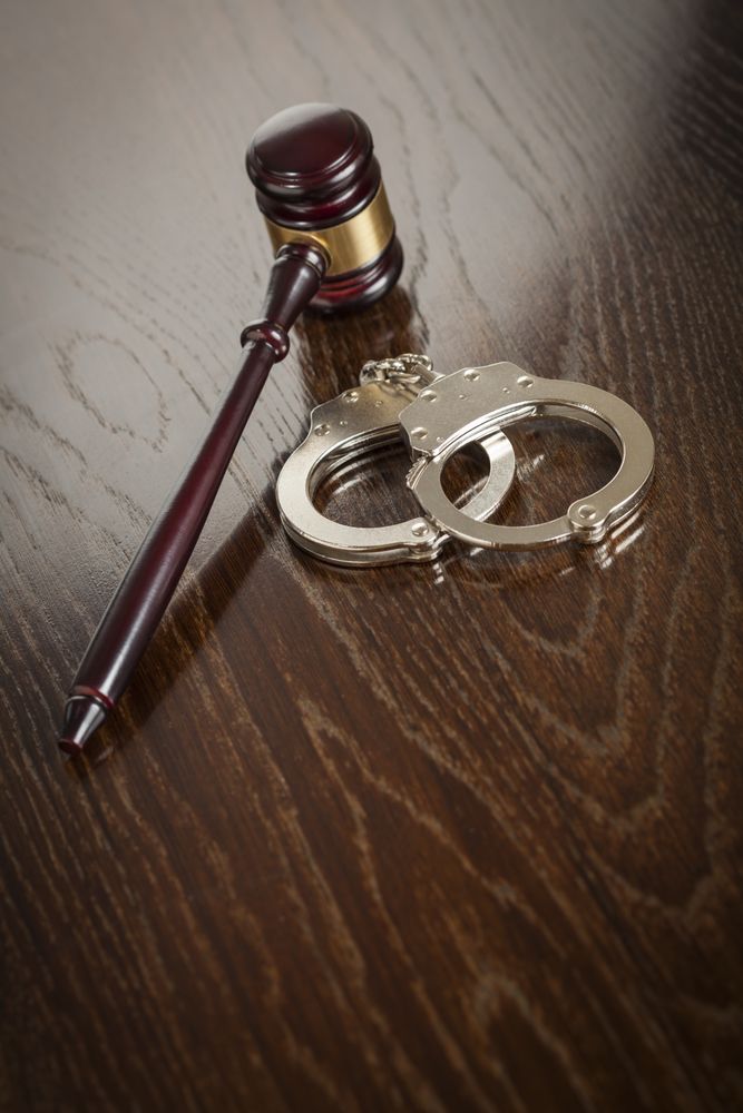 Gavel and Pair of Handcuffs on Table