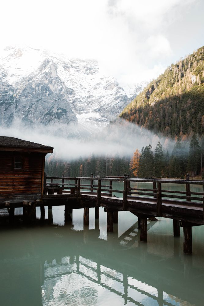 House on stilts on lake near mountains