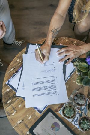Top view of woman signing a document