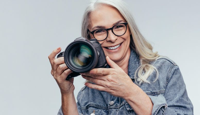 Beautiful woman photographer holding DSLR camera