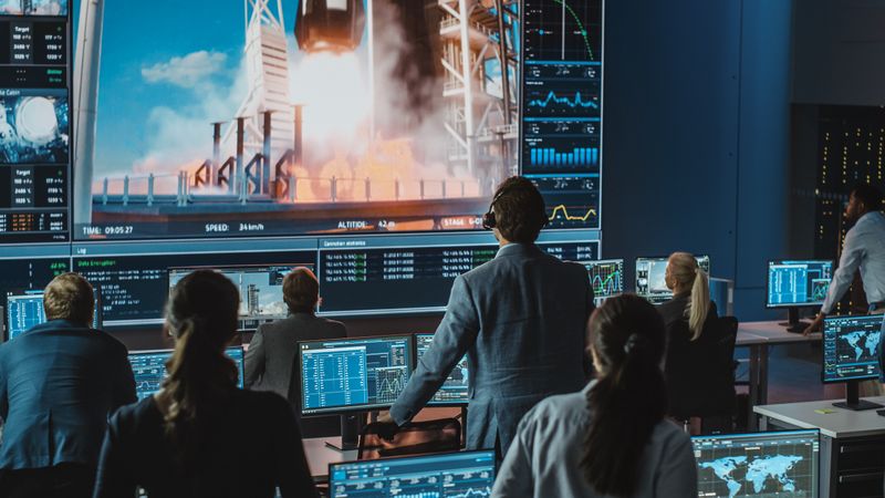 Diverse Team Monitors Rocket Launch Data in a High-tech Control Room