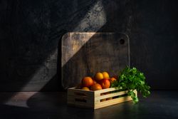 Box of plums with parsley