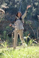 Hispanic woman waving hand during hiking