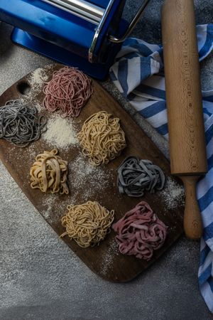 Variety of homemade pasta with rolling pin