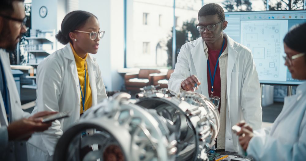Young Black Engineer Instructing and Leading his Team, Analyzing and Researching How a Futuristic Turbofan Motor Works.