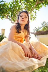 Girl sitting on grass and looking away