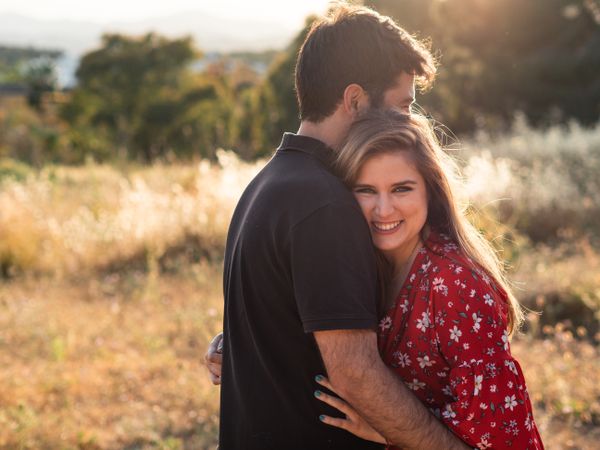 Young happy couple embracing in beautiful garden