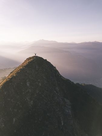 Person standing on top of mountain