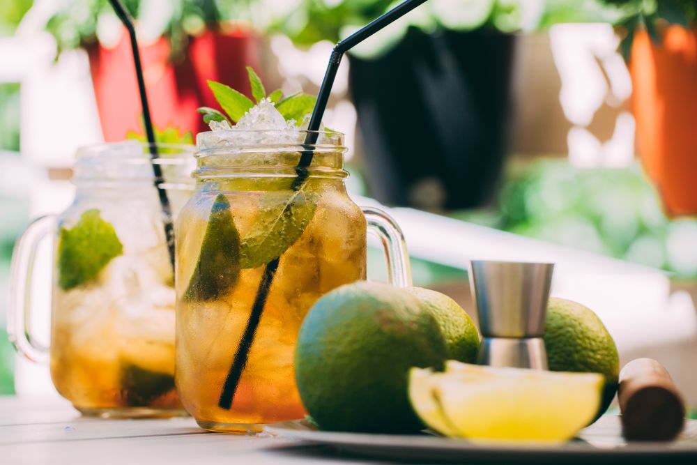 Mojito in mason jar and ingredients on wooden table